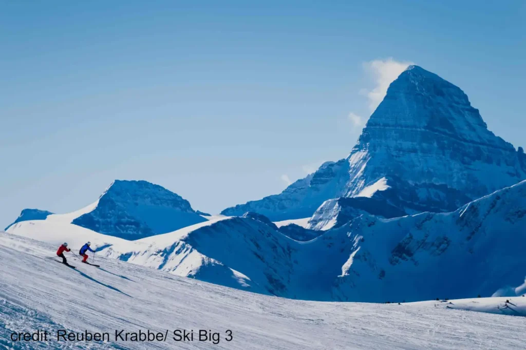 skiers on a groomed run in Banff