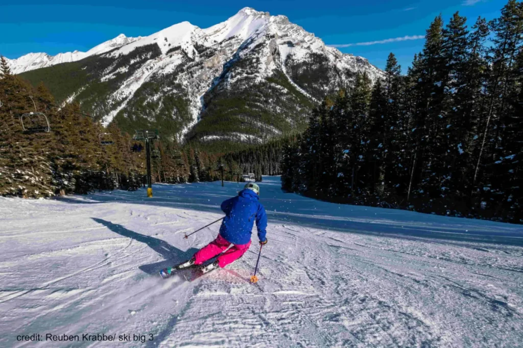skier descending a groomed run in Banff