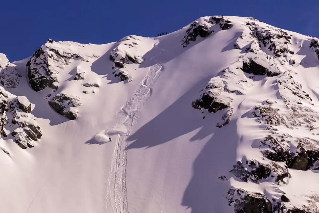 skier descending a steep chute in the Glacier Highway backcountry