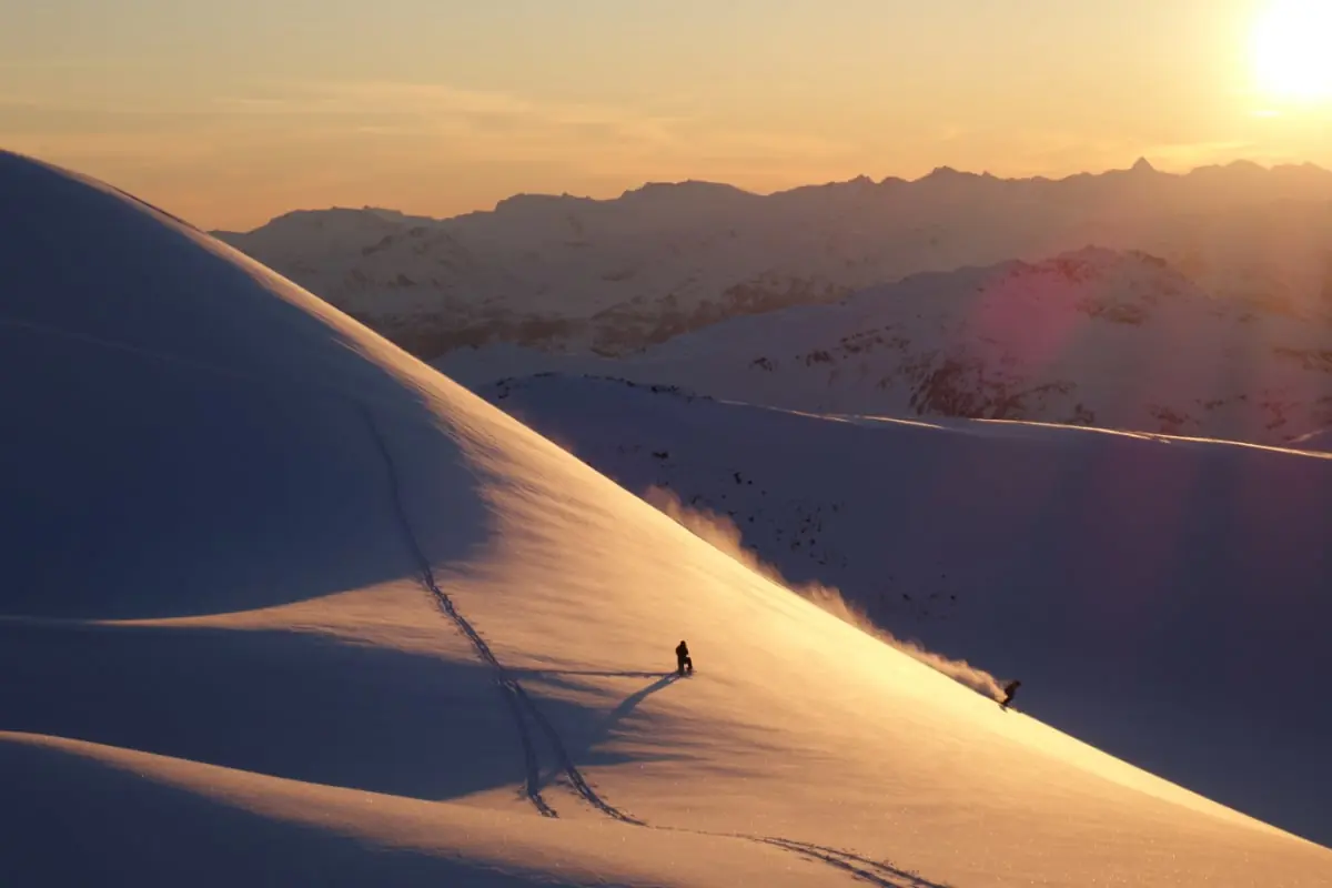 skiers at sunset in the backcountry