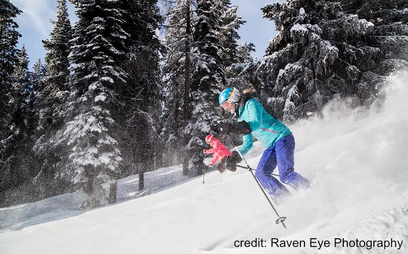two women skiing in powder at Kimberly Ski Resort