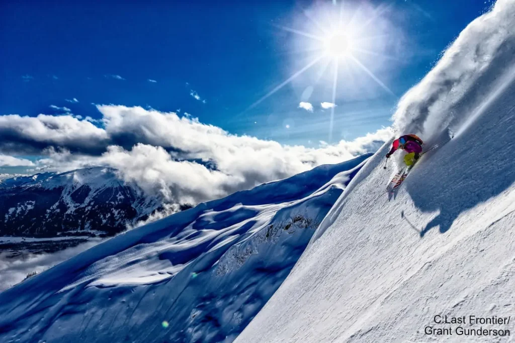 skier on a beautiful sunny day with Last Frontier heli skiing