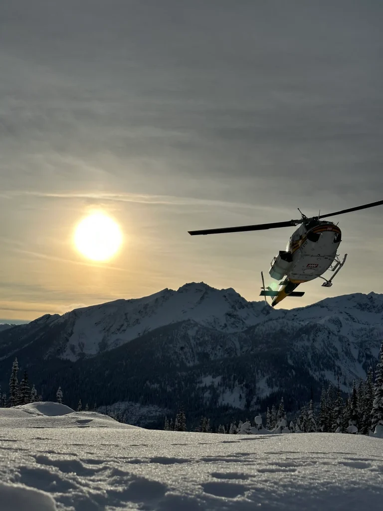 helicopter taking off in the sunset