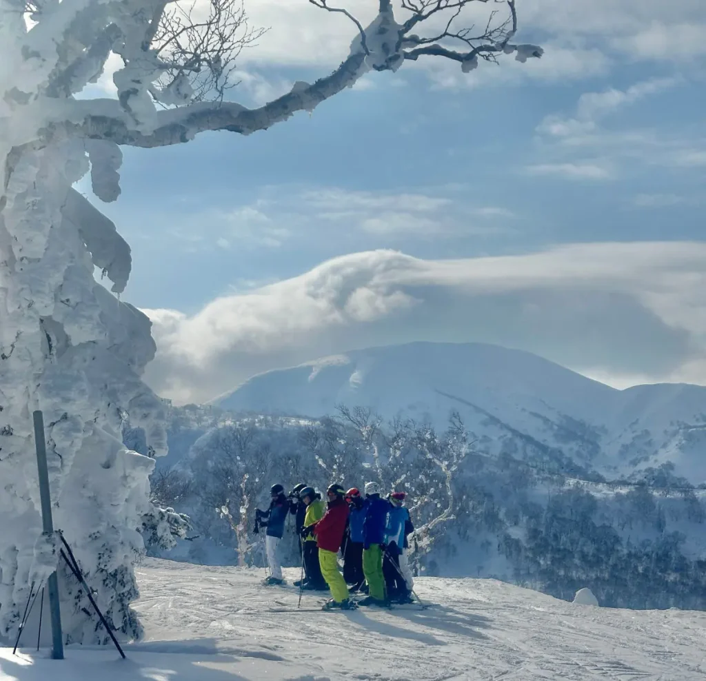 group of skiers atop a run in Kiroro, Japan